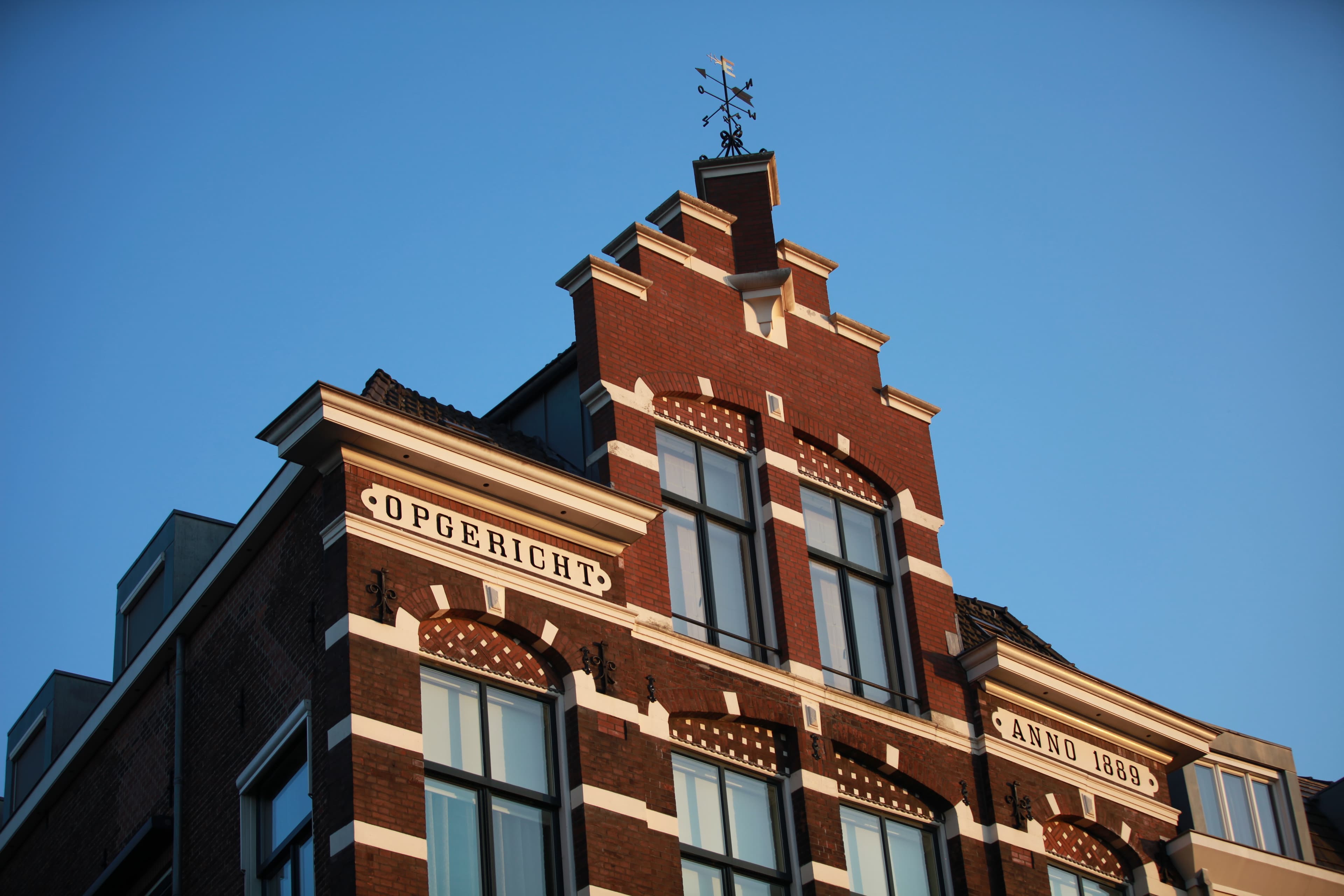 Sunlit historic Dutch gable beneath a clear blue sky