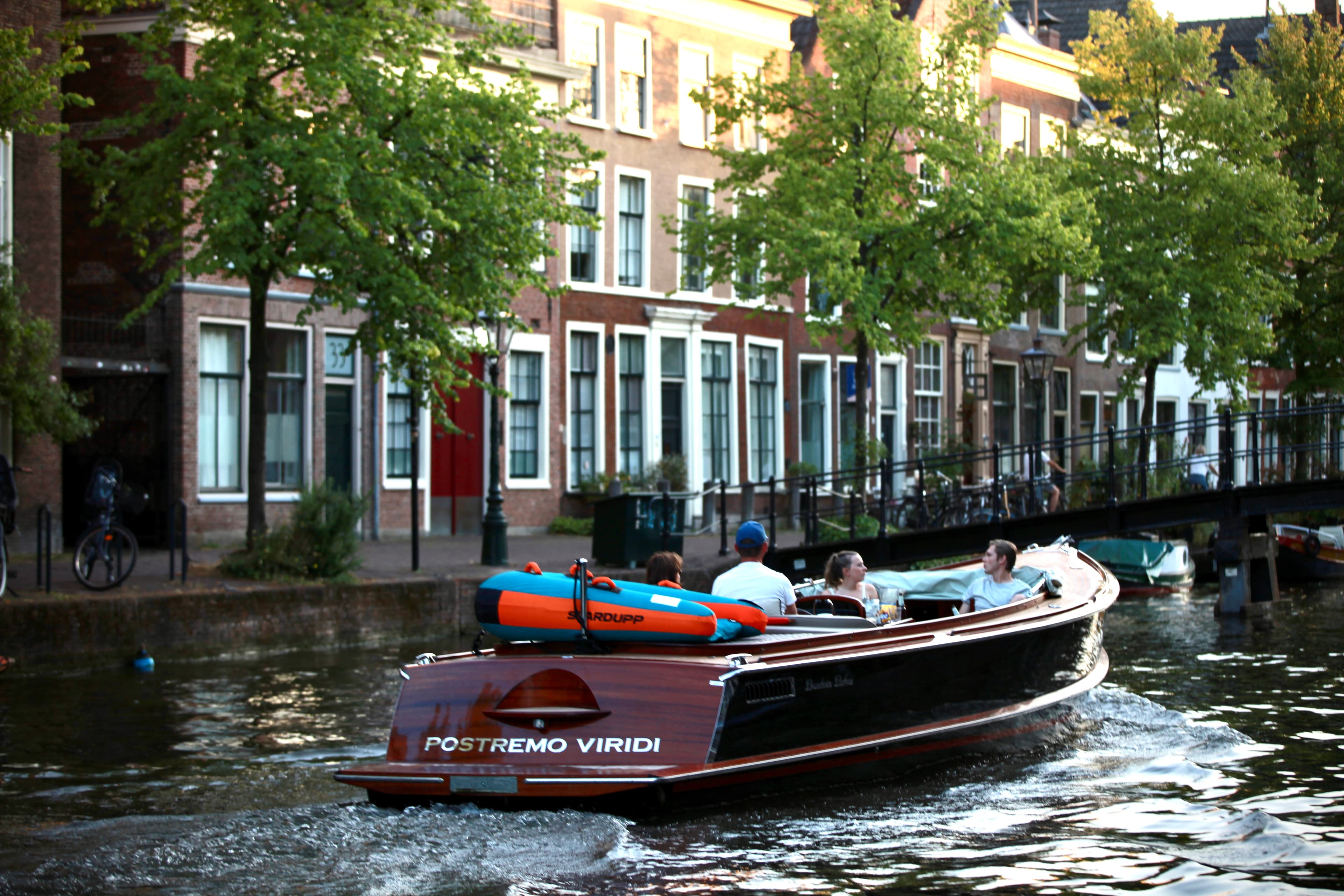 A small group travelling together by boat on a Leiden canal