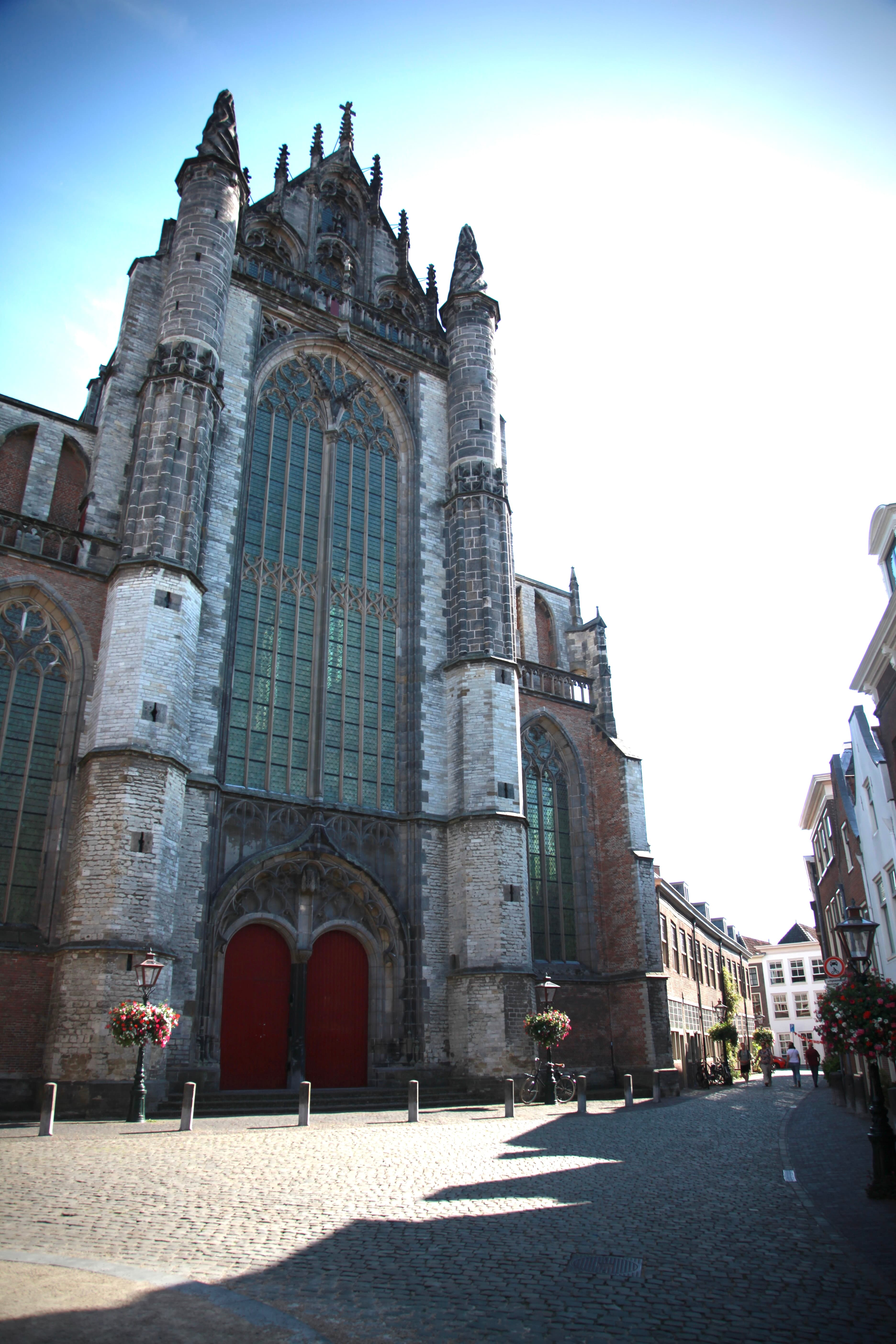 Tall Gothic façade of Pieterskerk above a quiet square