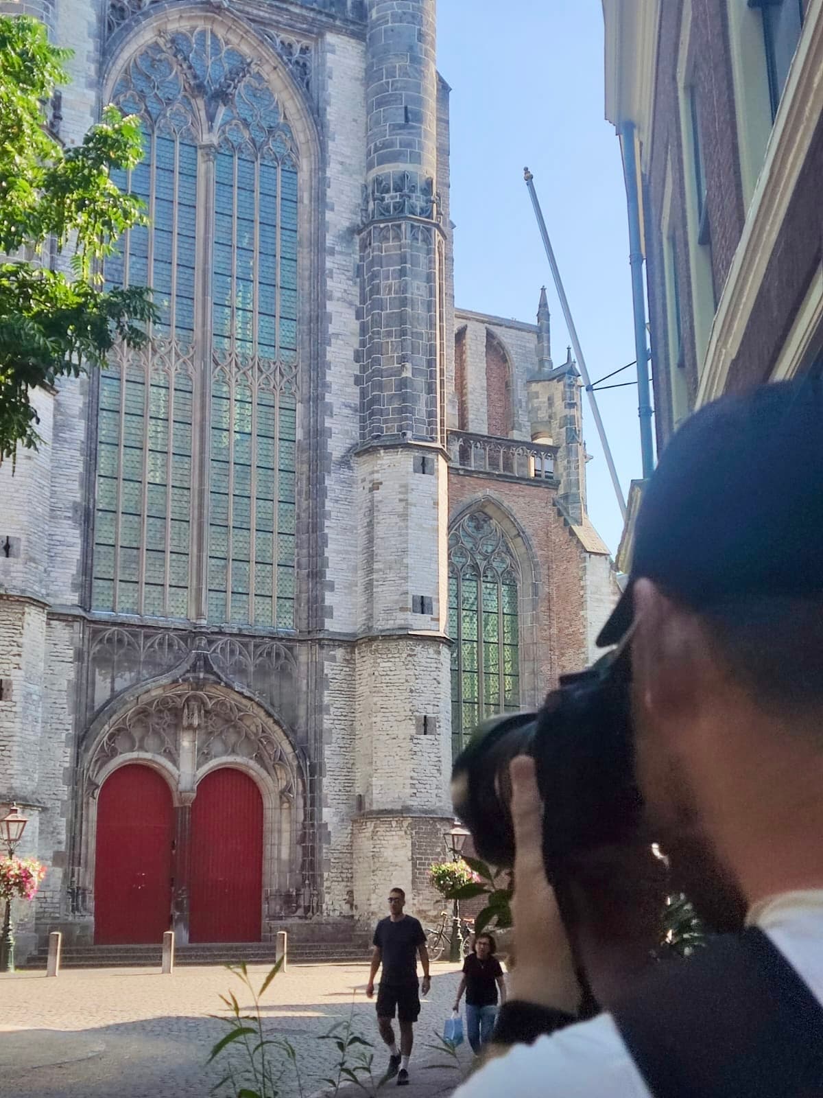 Photographer composing Pieterskerk from the surrounding street