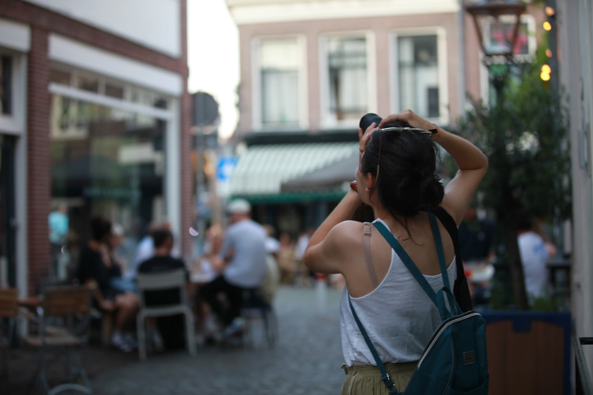 Traveller photographing a lively Leiden street