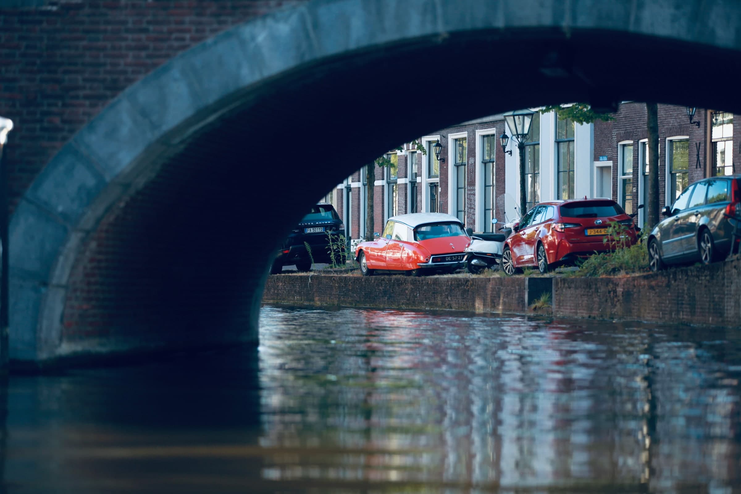 Canal framed by a bridge arch in Leiden