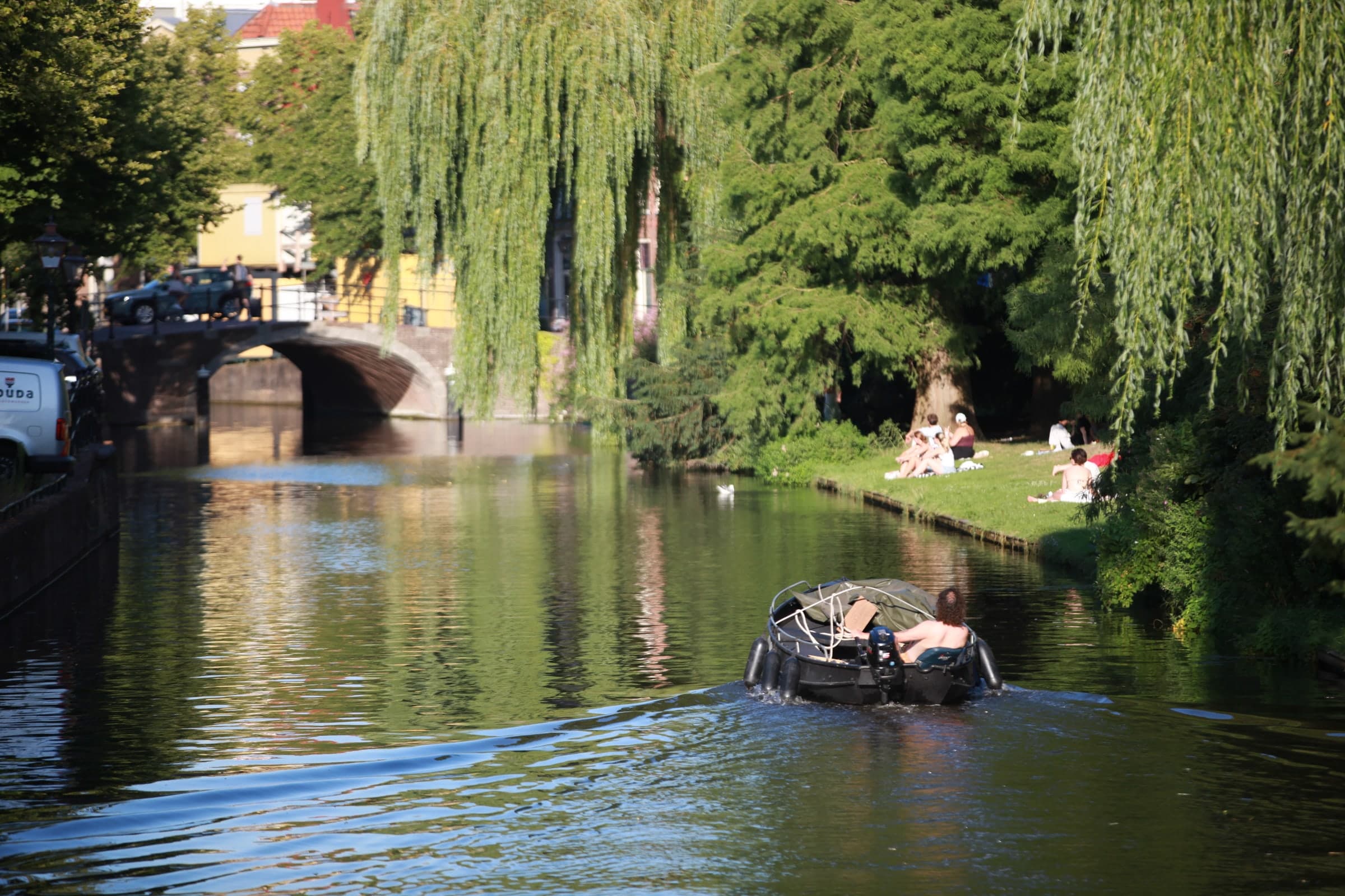 Rowboat along a leafy canal in Leiden
