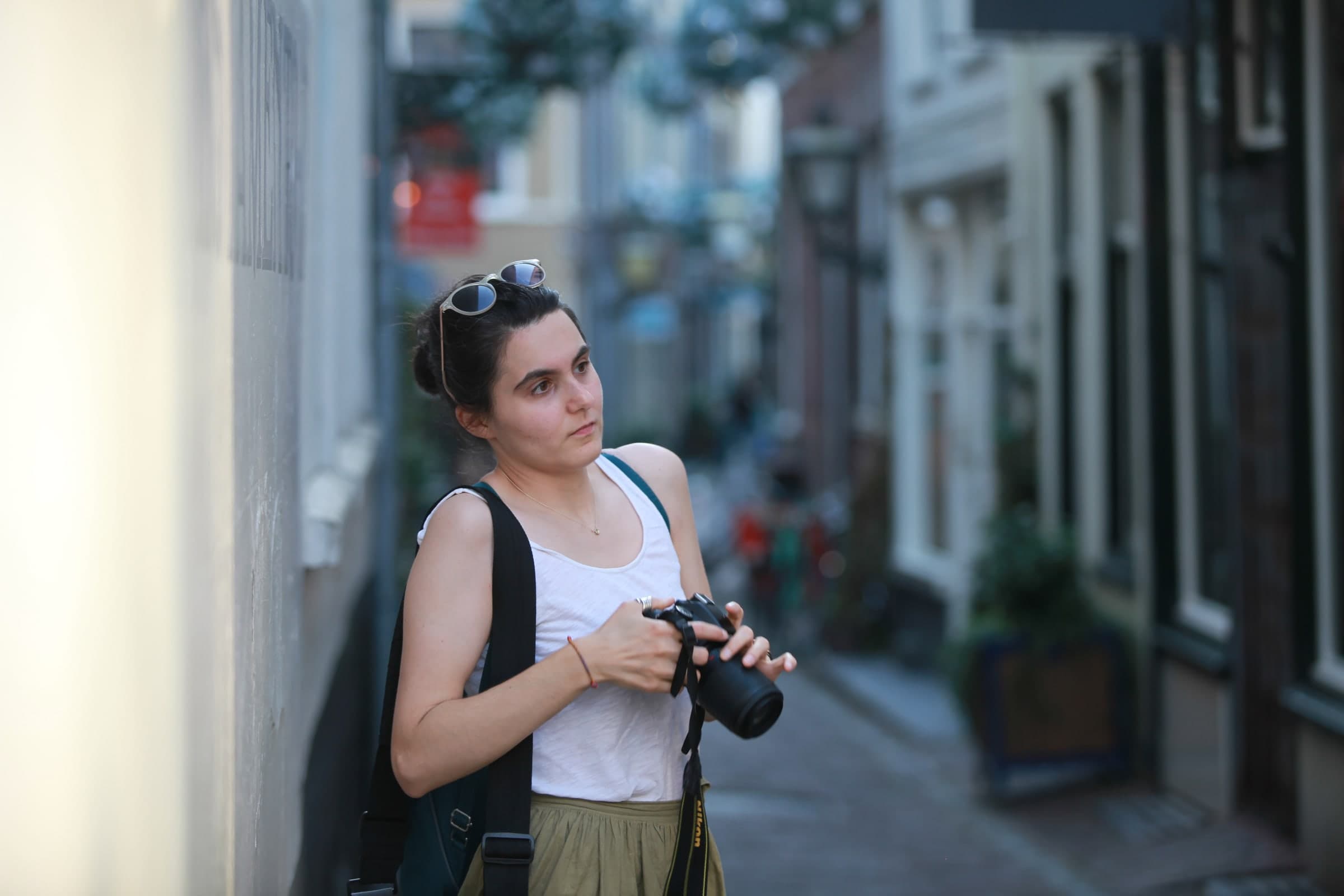 Photographer pausing in a narrow lane in Leiden