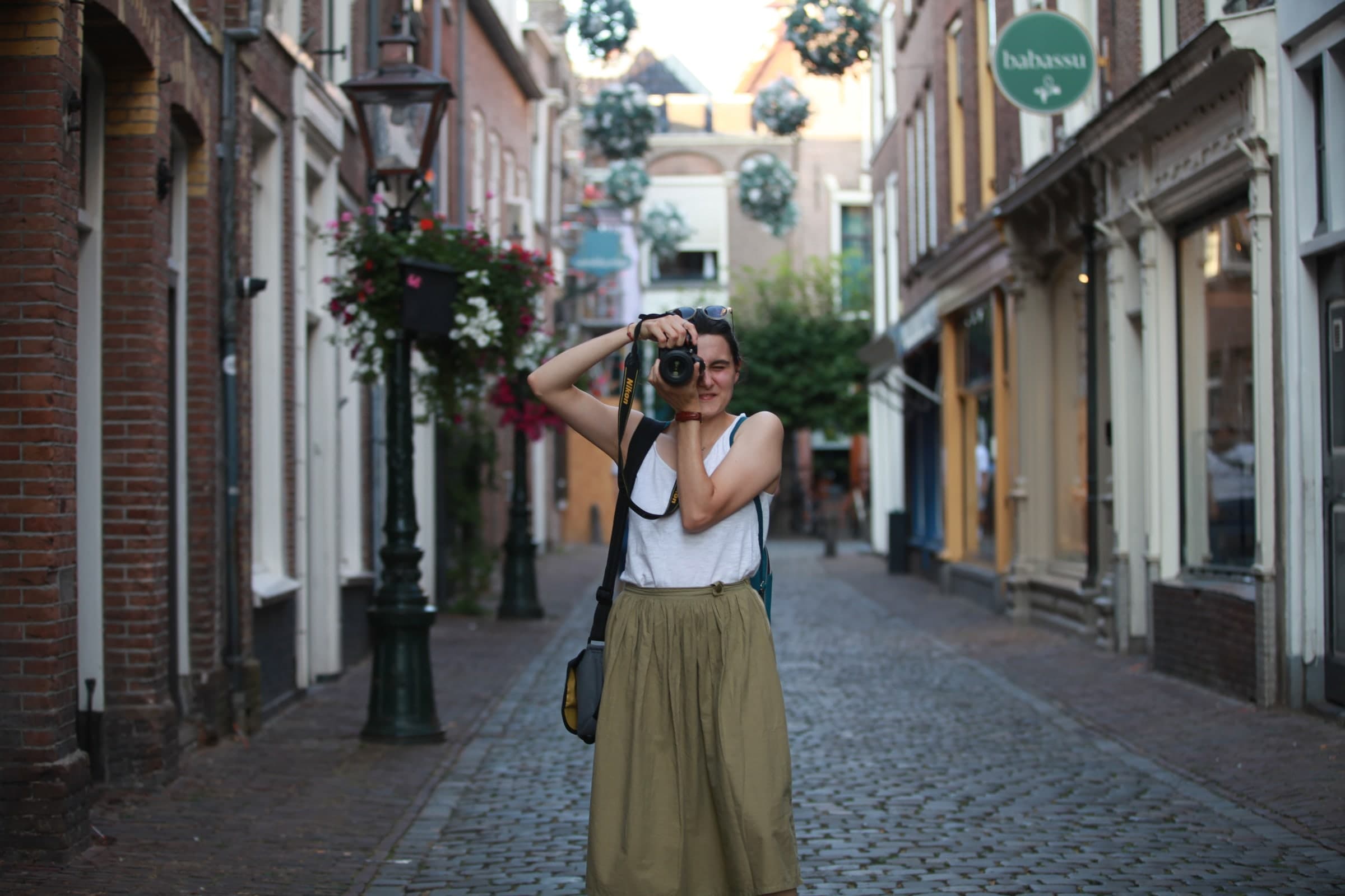 Photographer in a quiet cobbled lane in Leiden