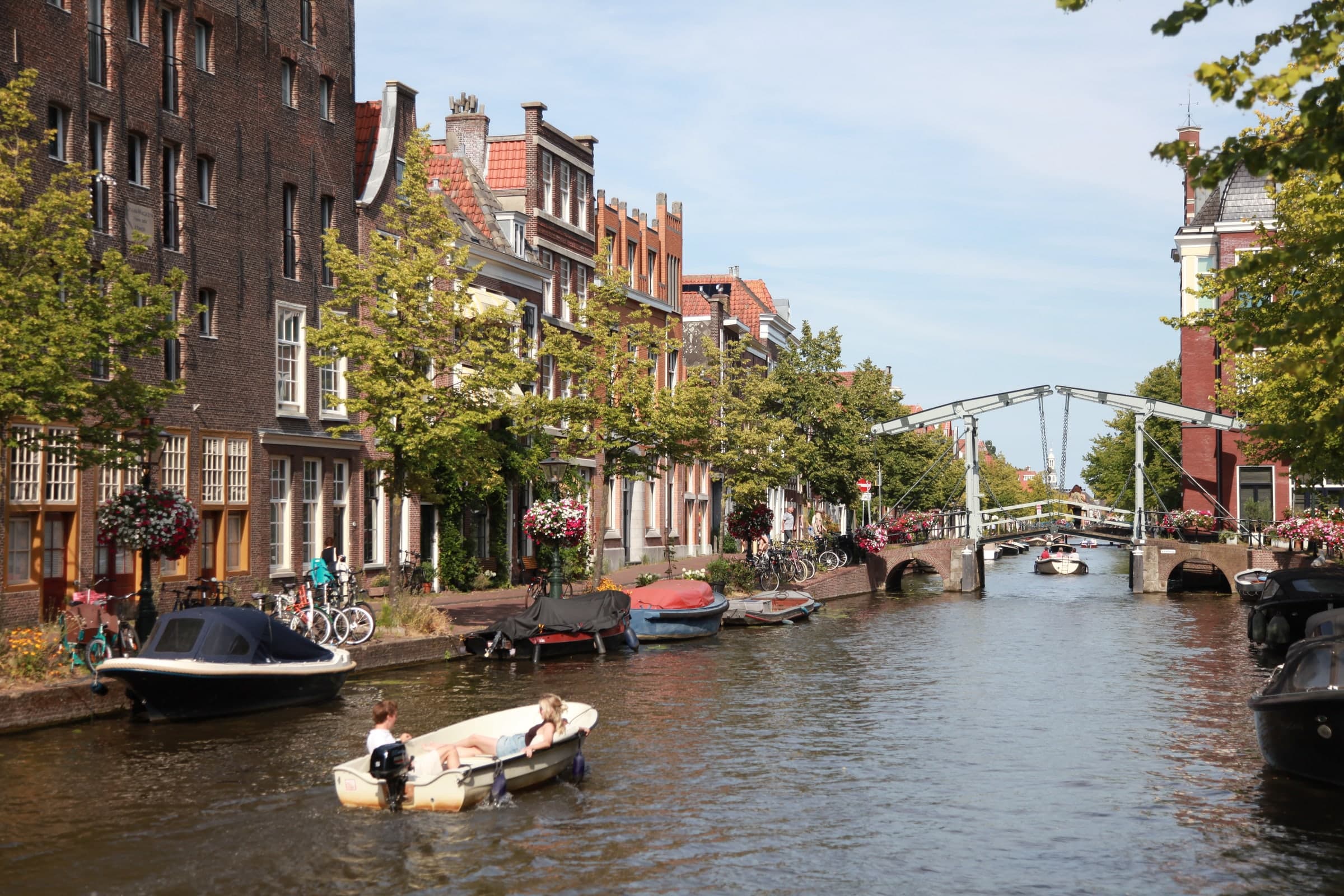 Boat passing Leiden canal houses in Leiden