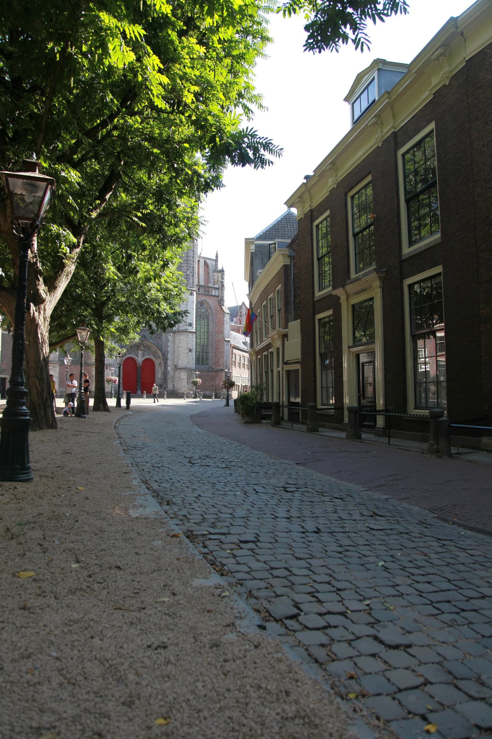 Quiet cobbled street beside a church in Leiden