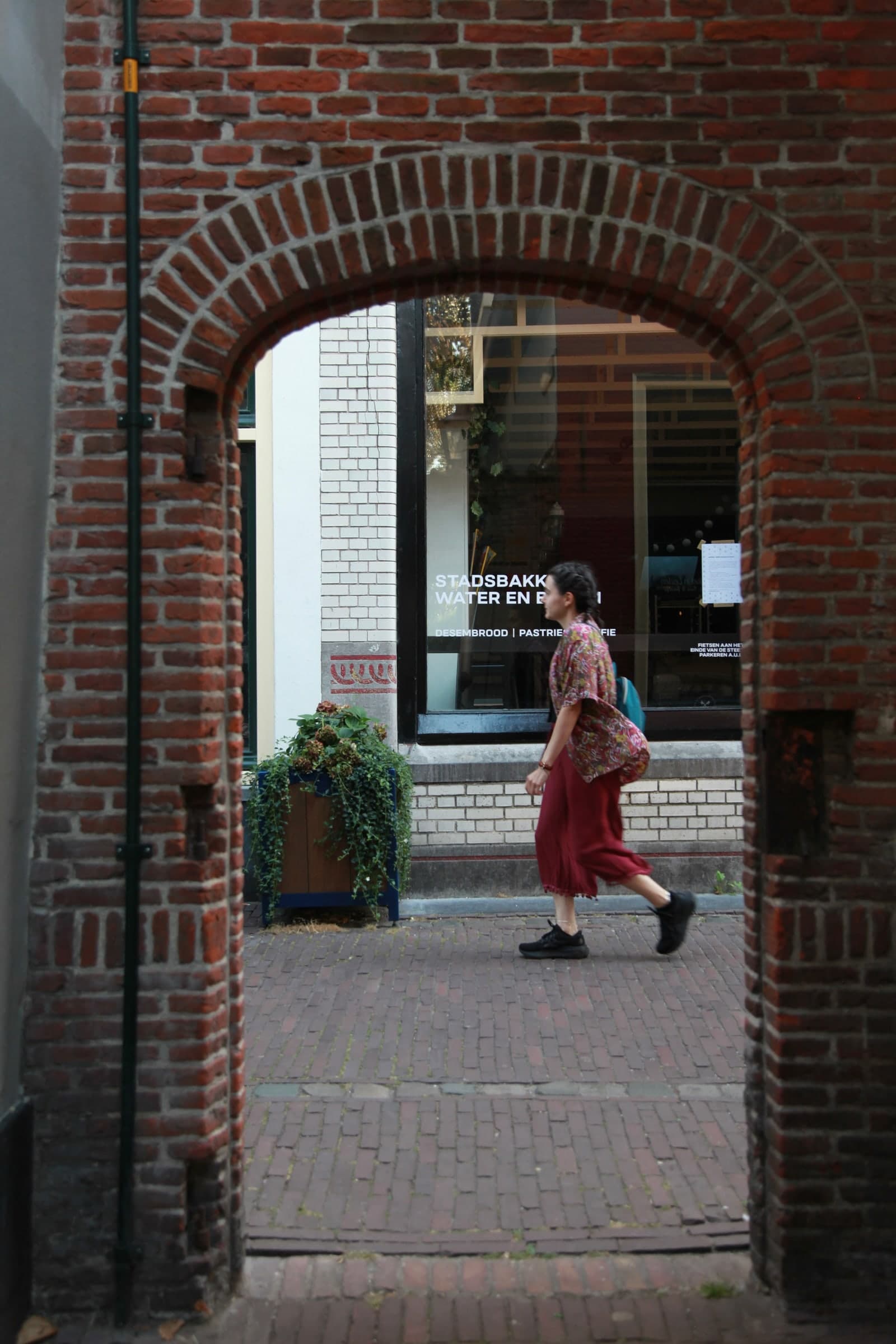 Woman walking past a historic workshop in Leiden