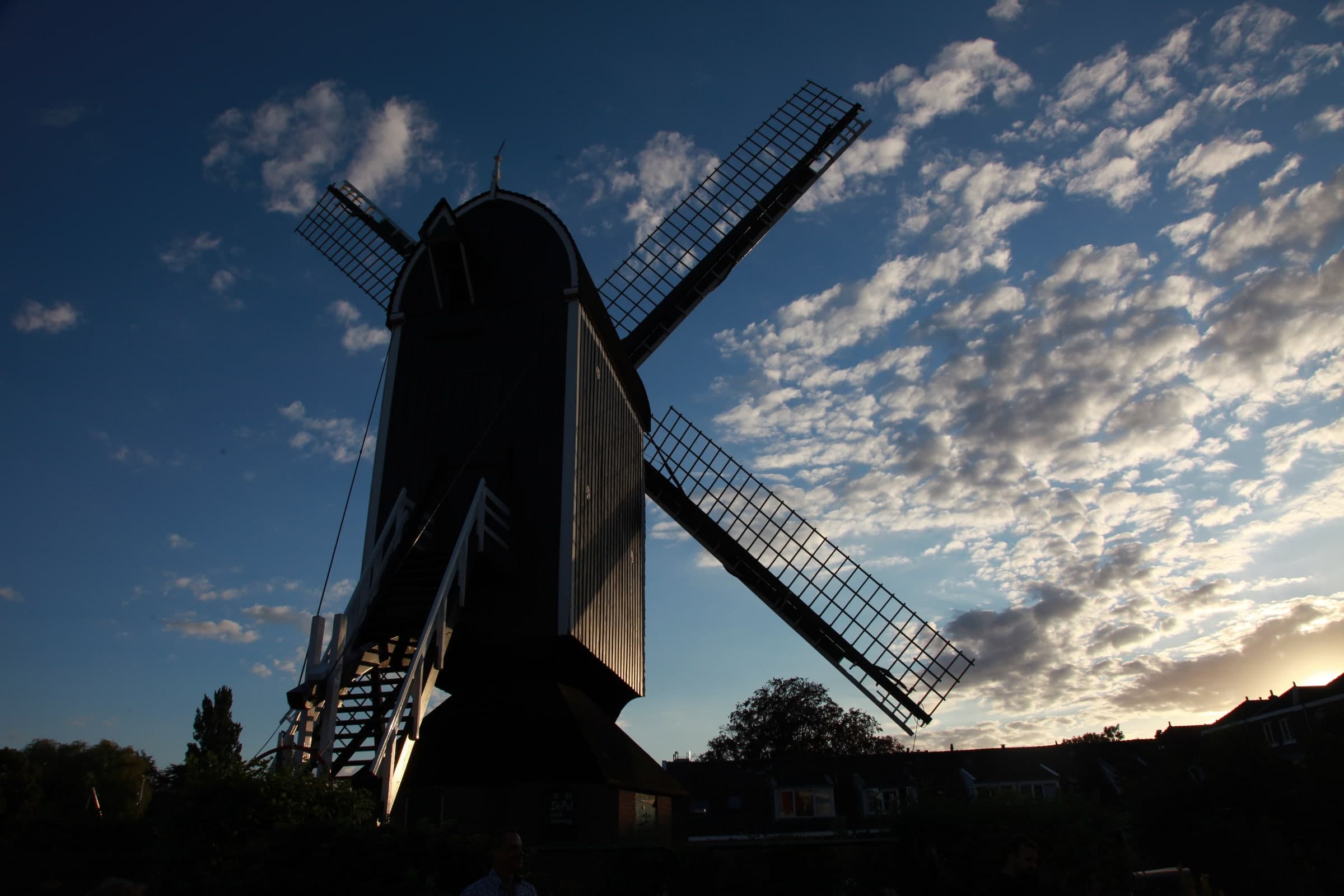 Molen De Put beneath textured clouds in Leiden
