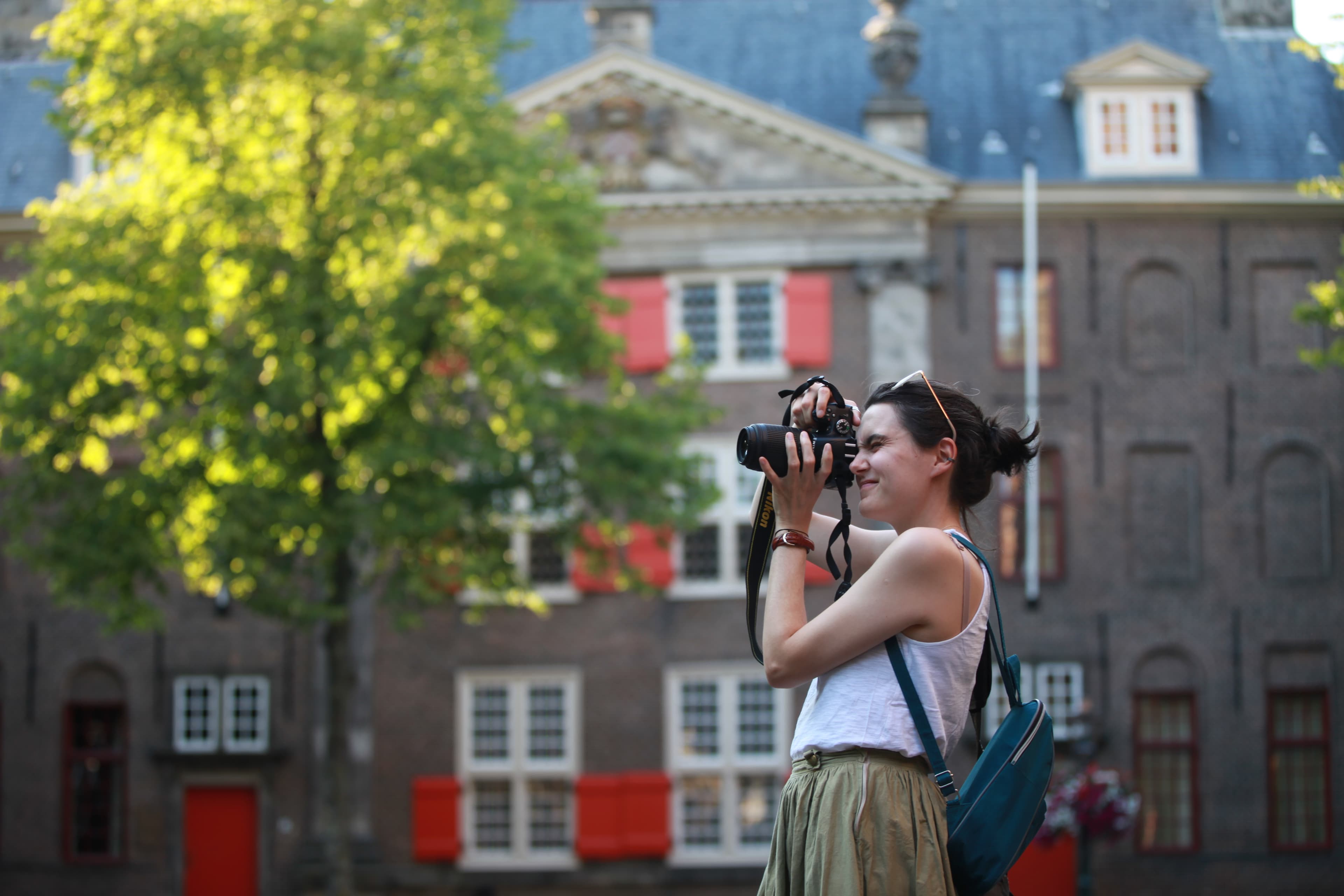 Travel photographer composing a photograph in historic Leiden