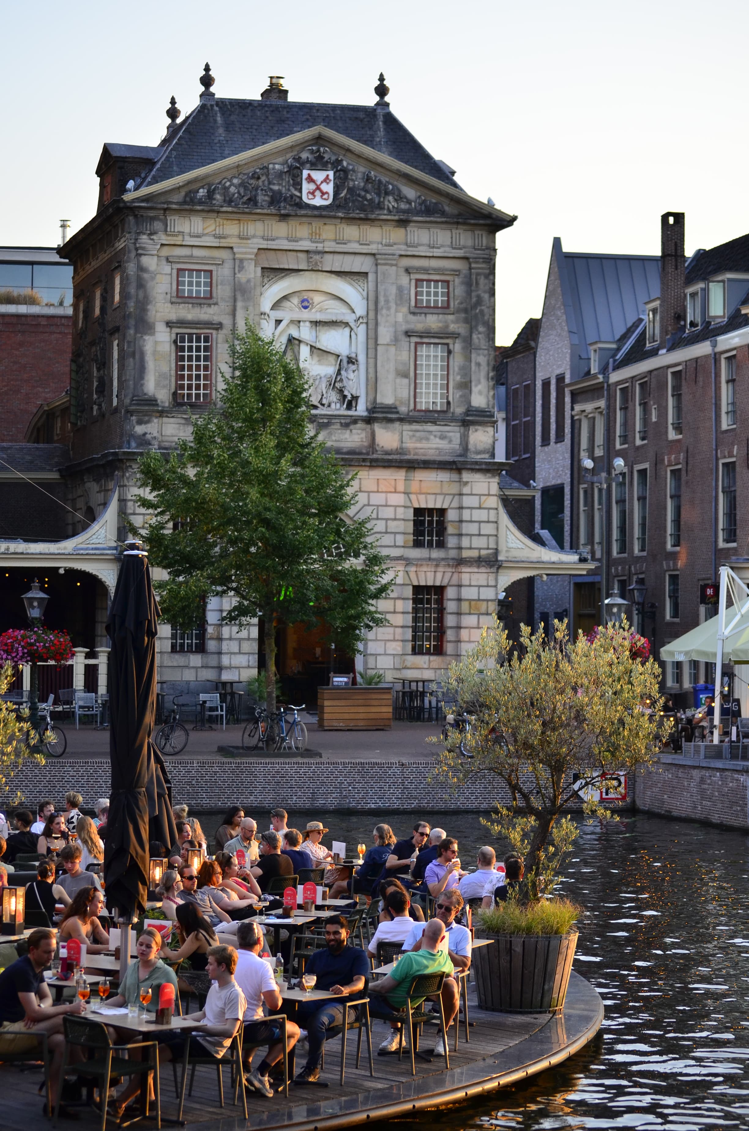 People enjoying a canal-side café terrace in the heart of Leiden