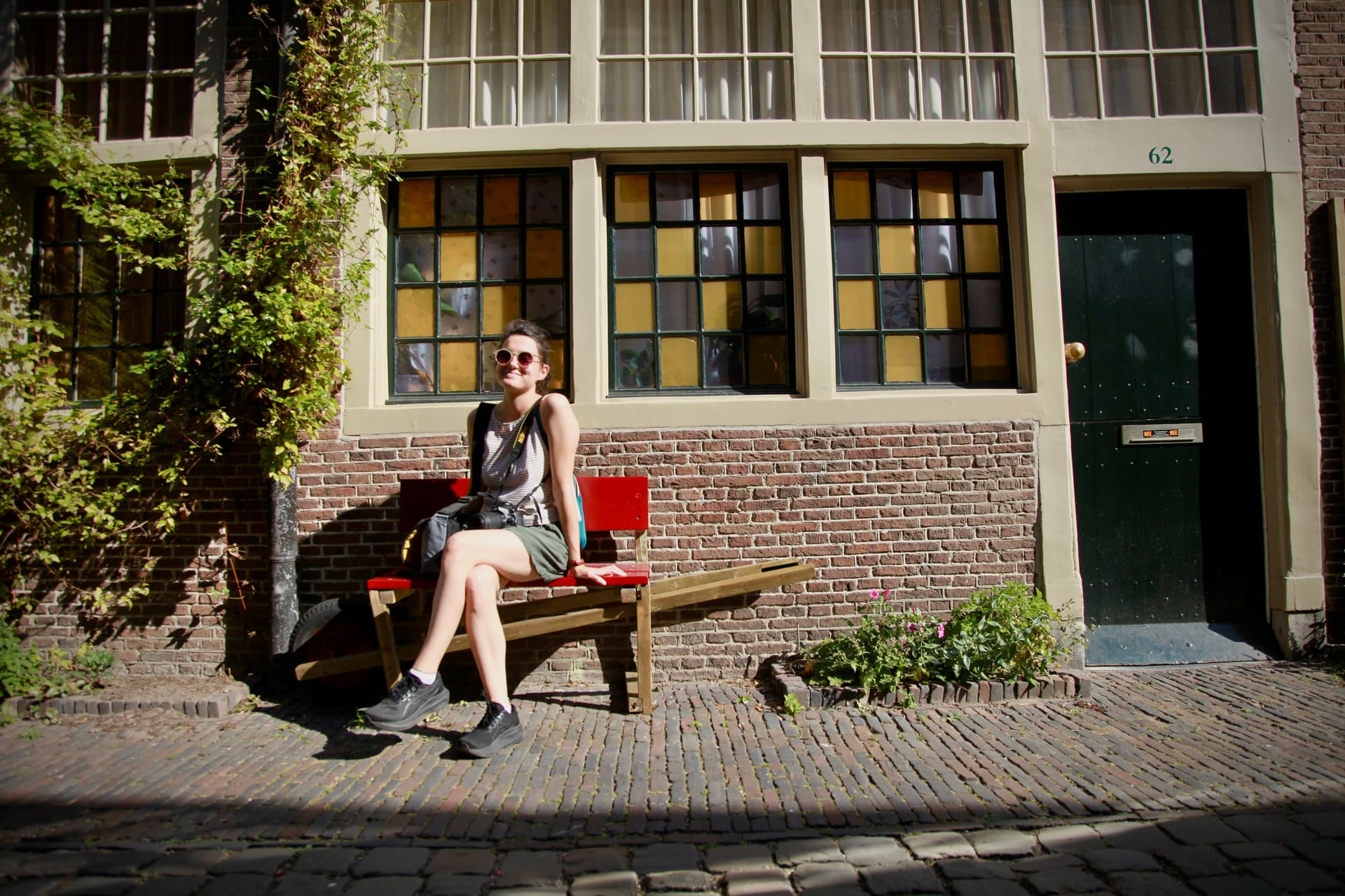 Traveller resting in a sunlit historic Leiden street